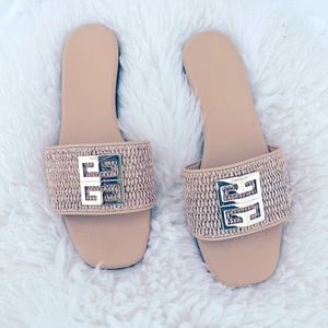 Tan flat sandal with gold branding